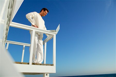 Man Standing on Balcony, Using Laptop Computer Stock Photo - Rights-Managed, Code: 700-00588906