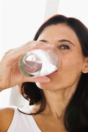 satisfied (thirst) - Woman Drinking Water Foto de stock - Con derechos protegidos, Código: 700-00592515