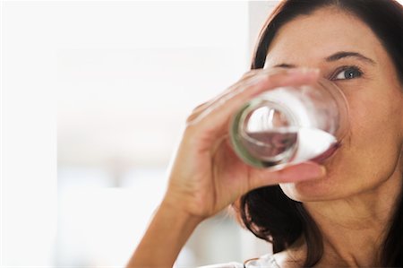 satisfied (thirst) - Woman Drinking Water Foto de stock - Con derechos protegidos, Código: 700-00592516