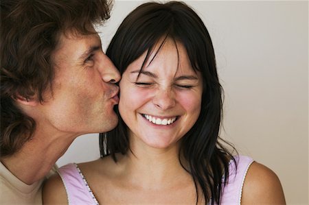 Man Kissing Woman on the Cheek Stock Photo - Rights-Managed, Code: 700-00592517