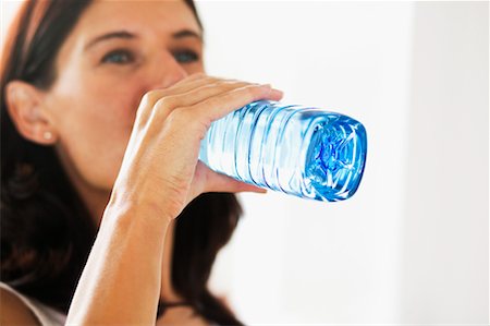 satisfied (thirst) - Woman Drinking Water Foto de stock - Con derechos protegidos, Código: 700-00592519