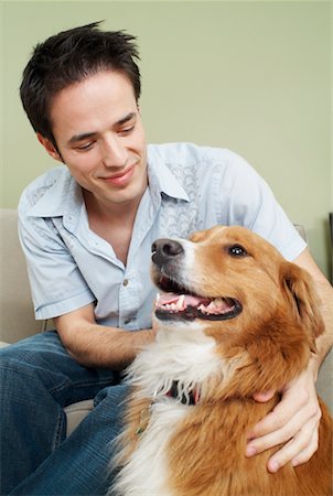Young Man Looking With Affection At Dog Foto de stock - Con derechos protegidos, Código: 700-00592747