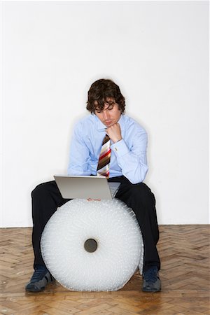 simsearch:700-03075217,k - Businessman Sitting on Bubble Wrap Roll Stock Photo - Rights-Managed, Code: 700-00604429