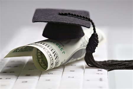 student loan - Mortarboard and Dollar Bill on Computer Keyboard Stock Photo - Rights-Managed, Code: 700-00605132