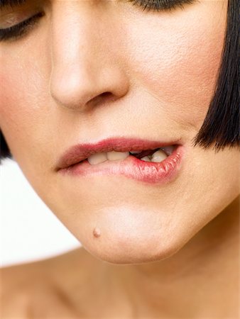 Woman Biting Her Lip Stock Photo - Rights-Managed, Code: 700-00606472