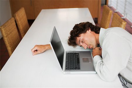 sleeping on boardroom table - Businessman Sleeping Next to Laptop Stock Photo - Rights-Managed, Code: 700-00606603