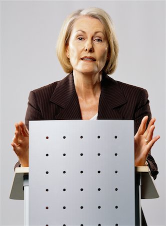 speaker at podium in auditorium - Businesswoman Giving Speech Stock Photo - Rights-Managed, Code: 700-00607467