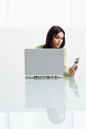 simsearch:700-06936091,k - Business Woman Using Cell Phone and Laptop Stock Photo - Rights-Managed, Code: 700-00607809