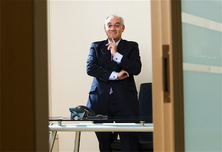 eyeglasses for lawyers - Businessman with Finger Touching Chin Stock Photo - Rights-Managed, Code: 700-00608446