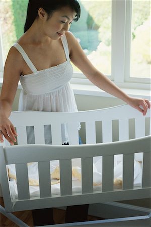Pregnant Woman Looking into Bassinet Stock Photo - Rights-Managed, Code: 700-00608656