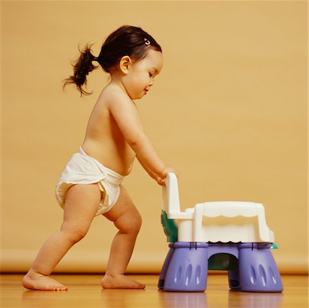 diapered toddler girls - Toddler Pushing Potty Stock Photo - Rights-Managed, Code: 700-00608681