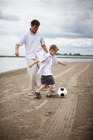 dad playing soccer with child - Father and Son Playing Outdoors Stock Photo - Rights-Managed, Code: 700-00609069