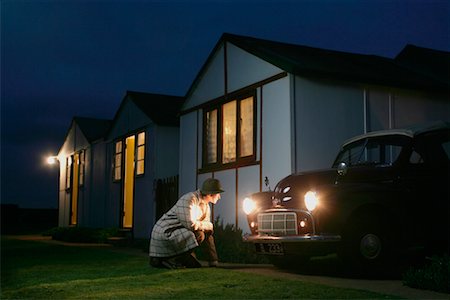 Woman Staring into Headlights of Parked Car Stock Photo - Rights-Managed, Code: 700-00609354