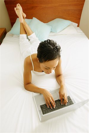 simsearch:700-00053497,k - Portrait of Woman Lying on Bed Using Laptop Computer Stock Photo - Rights-Managed, Code: 700-00609434