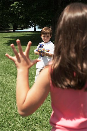 Boy Aiming Water Gun at Girl Stock Photo - Rights-Managed, Code: 700-00609511