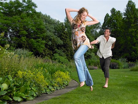 Man Chasing Woman Through Park Stock Photo - Rights-Managed, Code: 700-00609918