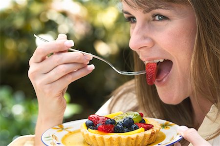 simsearch:600-00865934,k - Woman Eating Fruit Stock Photo - Rights-Managed, Code: 700-00610312