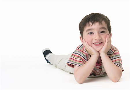 Portrait of Boy with Head in Hands Foto de stock - Con derechos protegidos, Código: 700-00610713