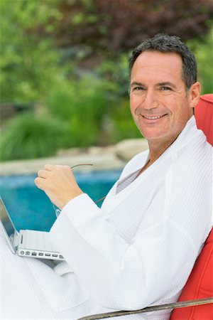 swimming pool man laptop - Man Using Laptop Computer Stock Photo - Rights-Managed, Code: 700-00610923