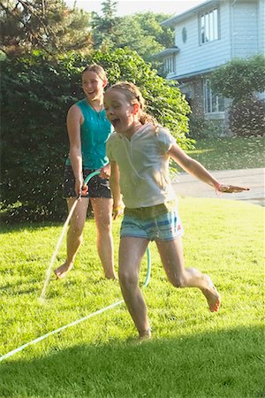 spraying water hose - Girls Playing Outdoors Stock Photo - Rights-Managed, Code: 700-00611055