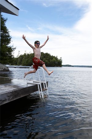 Boy Jumping into Lake Rosseau, Muskoka, Ontario, Canada Stock Photo - Rights-Managed, Code: 700-00611099