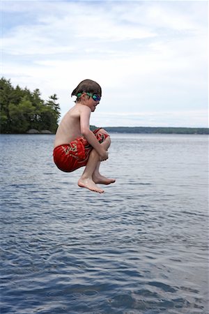 Boy Jumping into Lake Rosseau, Muskoka, Ontario, Canada Stock Photo - Rights-Managed, Code: 700-00611101
