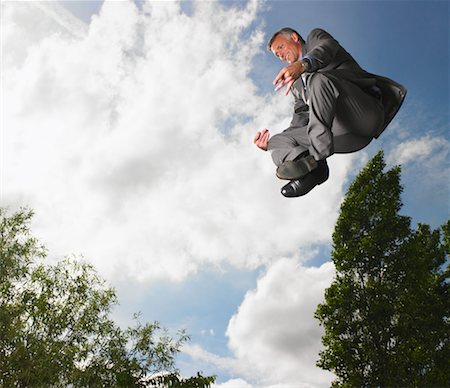 Businessman Meditating While Levitating Foto de stock - Con derechos protegidos, Código: 700-00611237