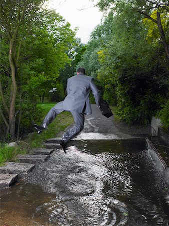 Businessman Jumping Over Puddle Stock Photo - Rights-Managed, Code: 700-00611245