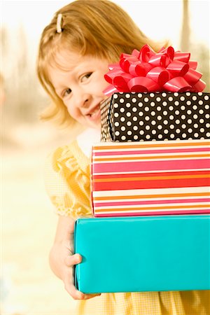 simsearch:632-01156362,k - Girl Holding Stack of Presents Stock Photo - Rights-Managed, Code: 700-00620312