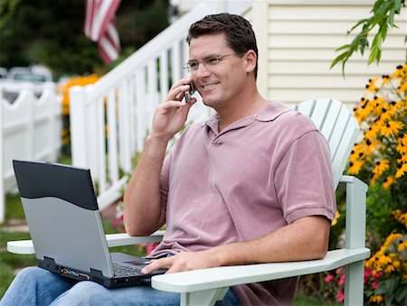 Man Using Laptop and Cell Phone Outdoors Stock Photo - Rights-Managed, Code: 700-00623001