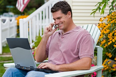 Man Using Laptop and Cell Phone Outdoors Stock Photo - Rights-Managed, Code: 700-00623002