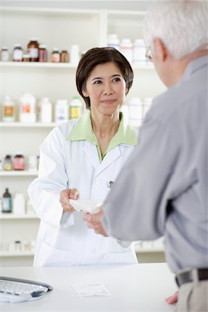 pharmacist talking client - Pharmacist Helping Customer Stock Photo - Rights-Managed, Code: 700-00623056