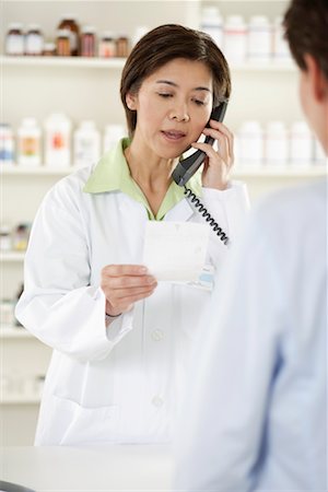 pharmacist phone - Pharmacist Helping Customer Stock Photo - Rights-Managed, Code: 700-00623060