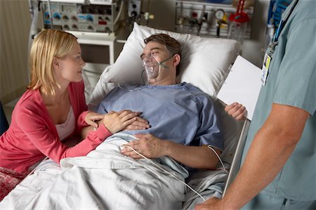 person in hospital bed overhead - Wife Visiting Husband in Hospital Stock Photo - Rights-Managed, Code: 700-00623293