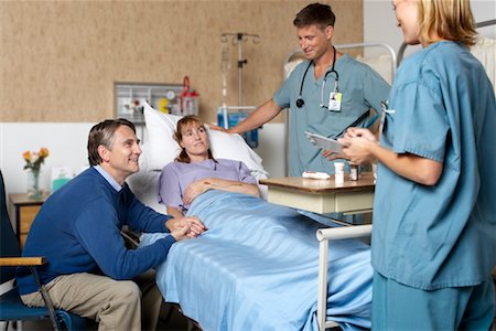 side images of dark hair nurse in uniform - Husband Visiting Wife in Hospital Stock Photo - Rights-Managed, Code: 700-00623303