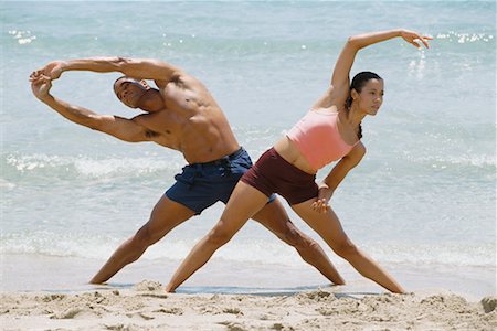 exercise black people water - Couple Stretching on Beach Stock Photo - Rights-Managed, Code: 700-00634111