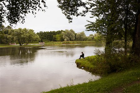 Man Fishing in Pond in Victory Park, St Petersburg, Russia Stock Photo - Rights-Managed, Code: 700-00634340