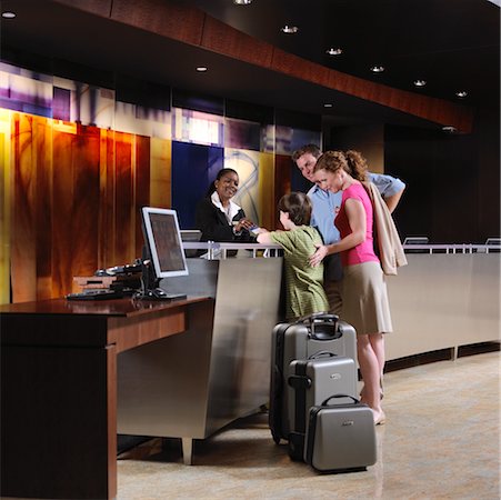 reservation - Family Checking in at Hotel Stock Photo - Rights-Managed, Code: 700-00635349