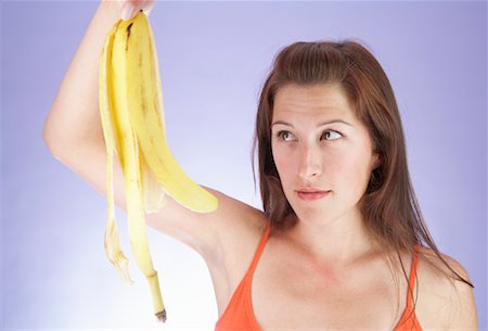 Woman Looking at Banana Peel Stock Photo - Rights-Managed, Code: 700-00635812