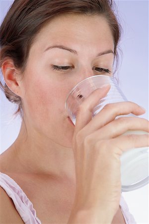 satisfied (thirst) - Woman Drinking Milk Foto de stock - Con derechos protegidos, Código: 700-00635832