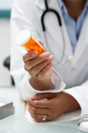 simsearch:600-03405632,k - Doctor Holding Pill Bottle Stock Photo - Rights-Managed, Code: 700-00639404