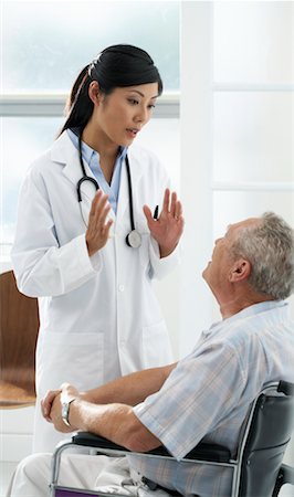 senior asian male doctor with stethoscope - Doctor with Patient Stock Photo - Rights-Managed, Code: 700-00639420