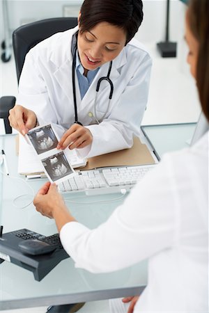 doctor showing results to patient - Doctor and Patient Looking at Ultrasound Stock Photo - Rights-Managed, Code: 700-00639449