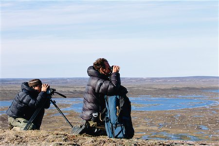 Men Looking through Binoculars, Banks Island, Northwest Territories, Canada Foto de stock - Con derechos protegidos, Código: 700-00639566