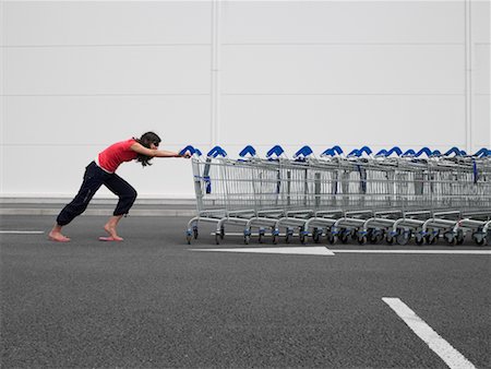 simsearch:700-01459203,k - Woman Pushing Grocery Carts In Parking Lot Stock Photo - Rights-Managed, Code: 700-00644035