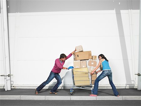 Couple Pushing Grocery Cart Full of Boxes Stock Photo - Rights-Managed, Code: 700-00644048