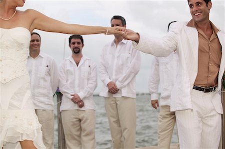 dock bride and groom pictures - Bride and Groom Dancing, Groomsmen in Background Stock Photo - Rights-Managed, Code: 700-00642528