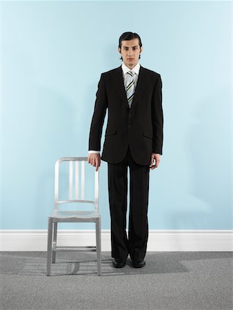 standing next to chair - Portrait of Businessman Stock Photo - Rights-Managed, Code: 700-00659443