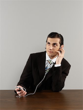 Businessman Listening to MP3 Player Stock Photo - Rights-Managed, Code: 700-00659494