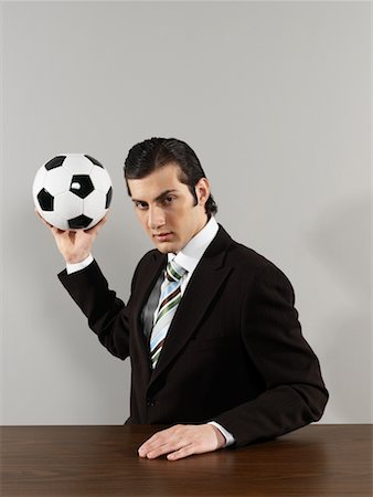 playing table soccer - Businessman Throwing Soccer Ball Stock Photo - Rights-Managed, Code: 700-00659580